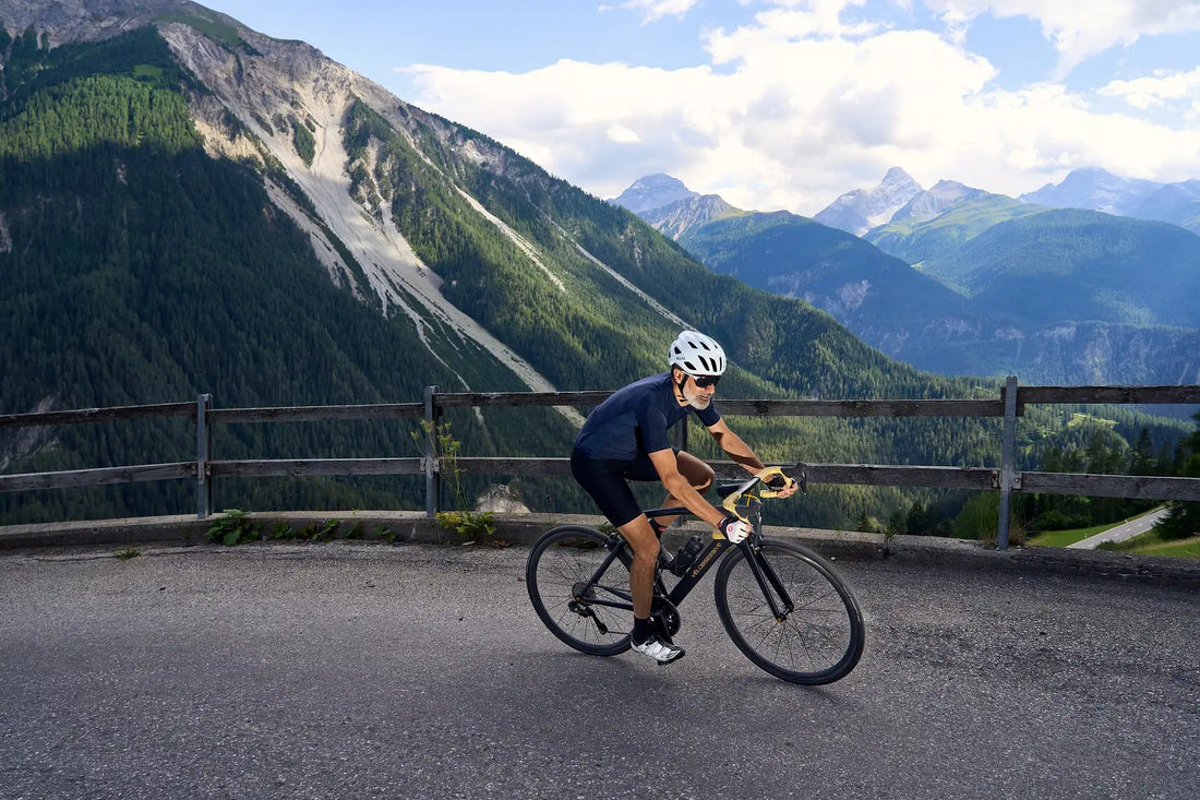 Cyclist climbing with a Vélobsessive road bike