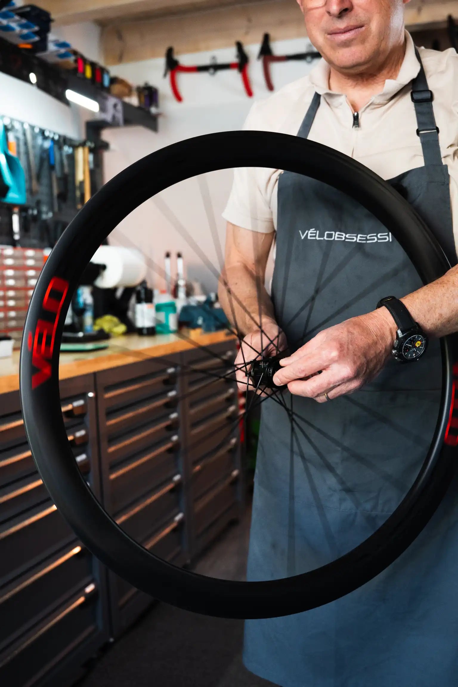 Thomas holding Flamme Rouge road bike wheel