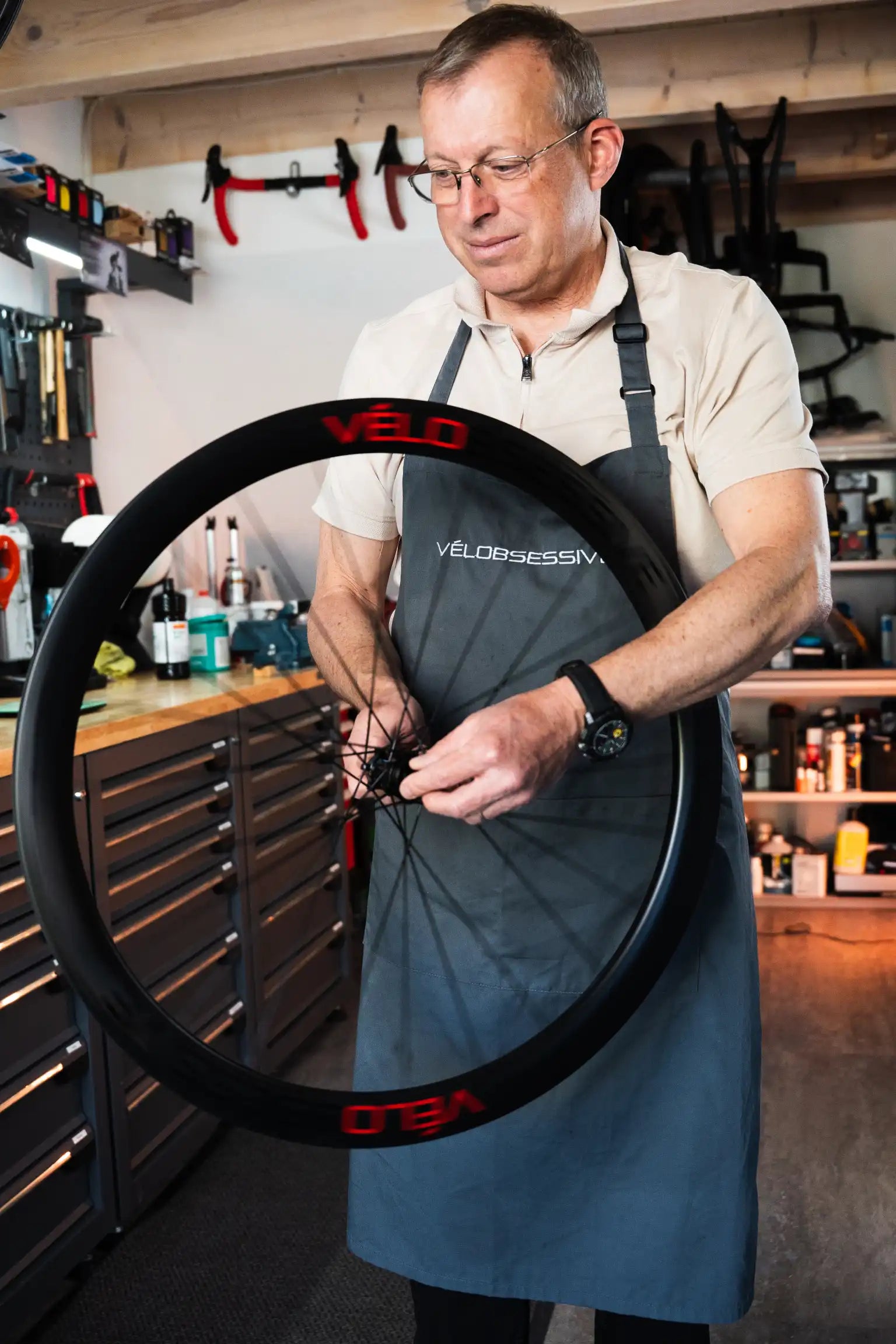 Thomas holding Flamme Rouge road bike wheel