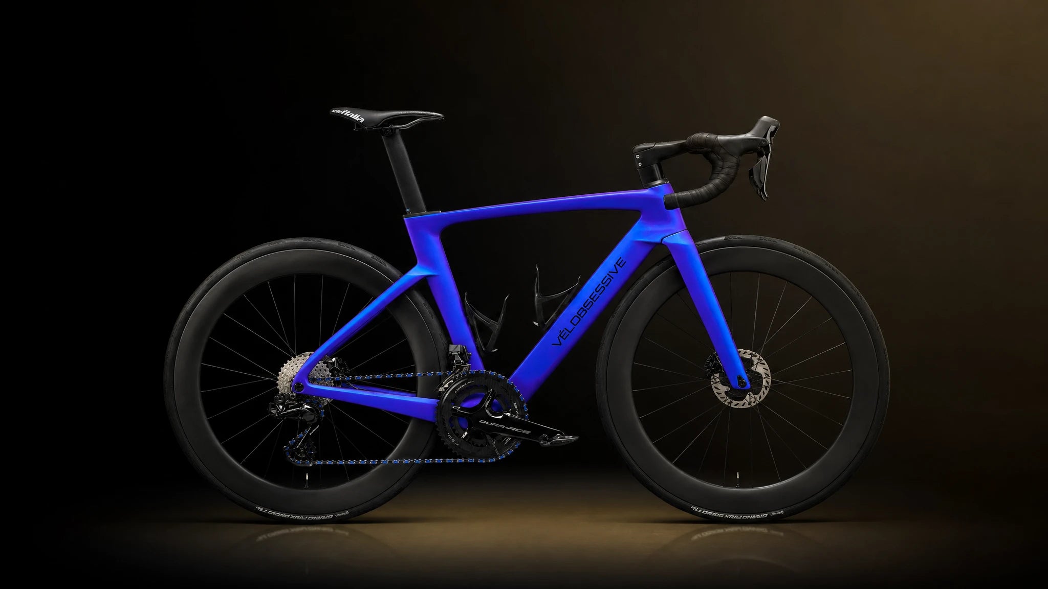 Horizontal Image of Vélobsessives Paradox Gravel Bike on a Black background with subtle orange gradient.