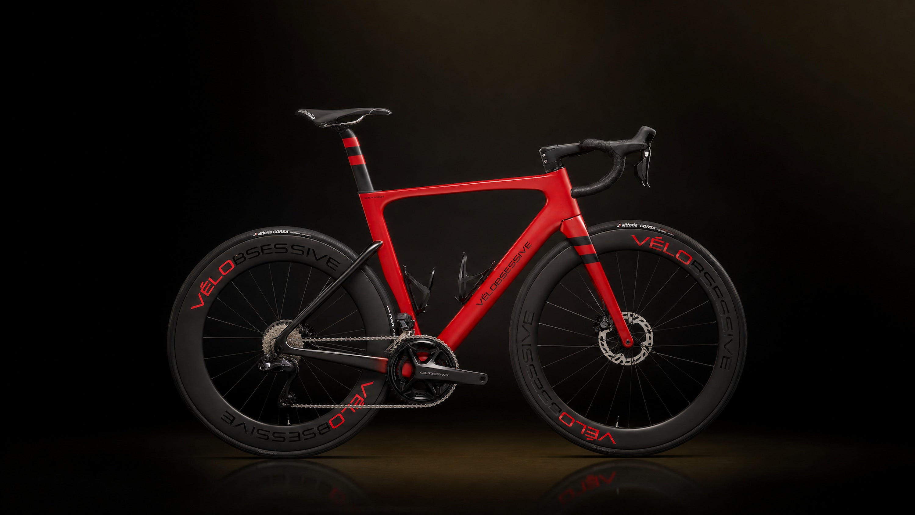 Horizontal Image of Vélobsessives Flamme Rouge Road Bike on a Black background with subtle orange gradient.